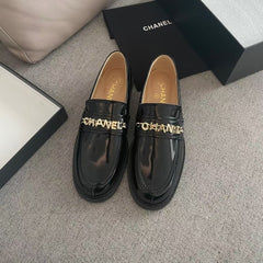 MOCCASINS IN BLACK CALFSKIN GOLD METAL LOGO
