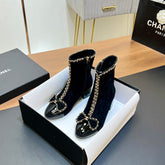 CHANEL 25S HEELED CHAIN BOOTS WITH BOW IN BLACK VELVET GOLD HARDWARE