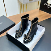 CHANEL 25S HEELED CHAIN BOOTS WITH BOW IN BLACK CALFSKIN GOLD HARDWARE