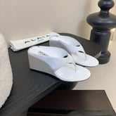 ALAIA WEDGE THONG SANDALS 25S IN WHITE SATIN