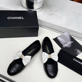 CHANEL 25S MARY JANES IN BLACK CALFSKIN WITH WHITE BOW GOLD HARDWARE