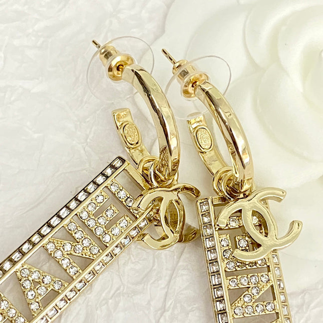 CC TEXT DIAMOND PAVED LIGHT GOLD DROP EARRINGS